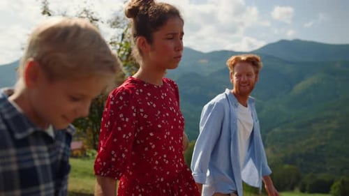 Carefree Summer Family Vacation in Mountains. Side View of Friendly People Walking