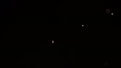 Animated Particles Rising and Falling on Black Background