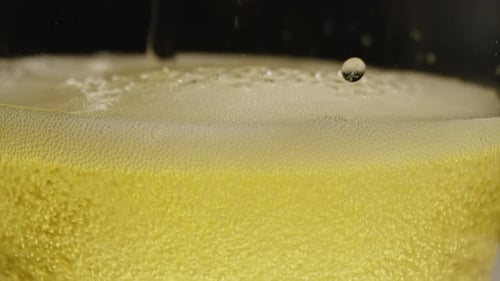 Close Up of Beer Being Poured Into Glass