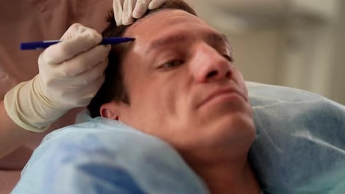 Man Receiving Forehead Exam in Medical Clinic