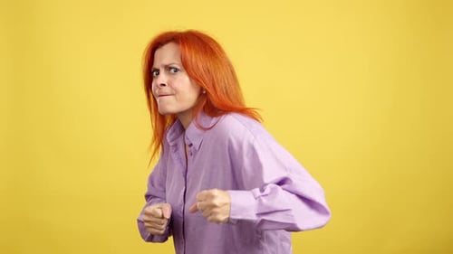 Woman with Orange Hair in Defensive Pose