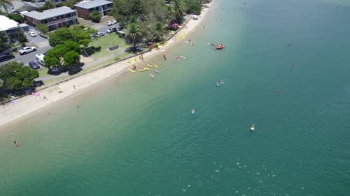Stand-up Paddleboarding On Serene Waters Of Tallebudgera Creek In Queensland, Australia. aerial tilt