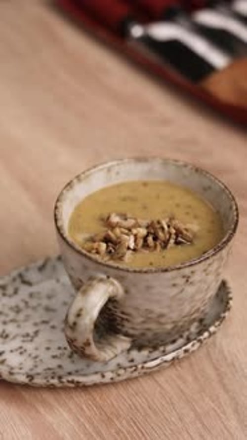 The chef is preparing a puree soup in the kitchen. Close-up