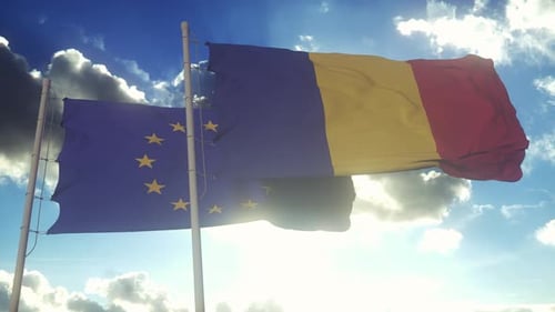 European Union and Romania Flags Waving Together in Blue Sky