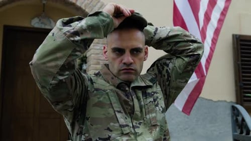 American Young Military Man Puts On His Uniform Before Going To Work