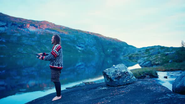 Man Fishing On A Lake In Rago National Park In Norway - Wide Shot ...