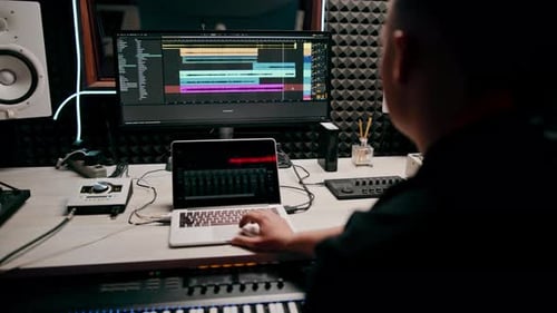 recording studio sound engineer producer mixes songs on screen colorful audio tracks professional