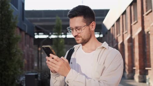 Young Adult Using Smartphone in Urban Setting
