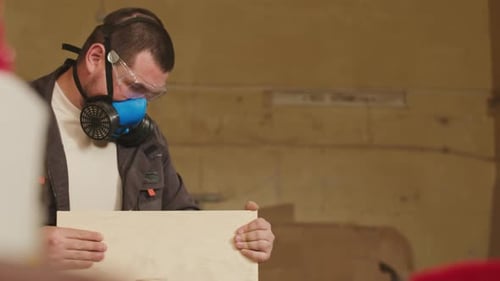 Joiner Processing Sides of Wooden Plank in Workshop