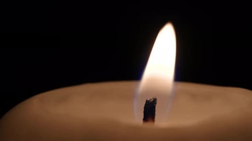 Close Up of Burning Candle in the Dark
