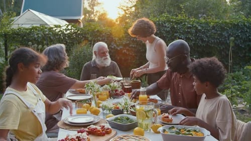 Family Gathering for Outdoor Meal in Golden Light