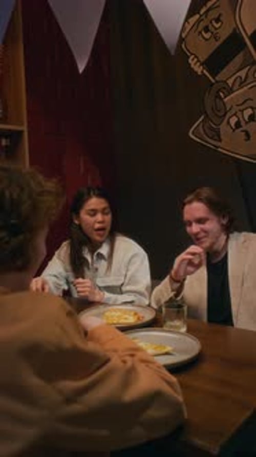 Group of Two Men and Woman Chatting During Birthday Party Celebration in Bar