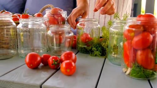 Woman Canning Fresh Red Tomatoes at Home