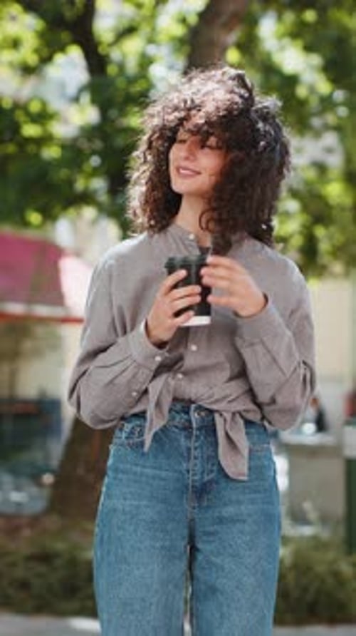 Happy Young Woman Enjoying Drinking Morning Coffee Hot Drink Relaxing Taking a Break on City Street