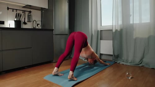 Woman Practicing Yoga in Home Interior