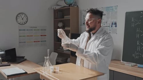 Scientist Mixing Chemicals in Science Classroom