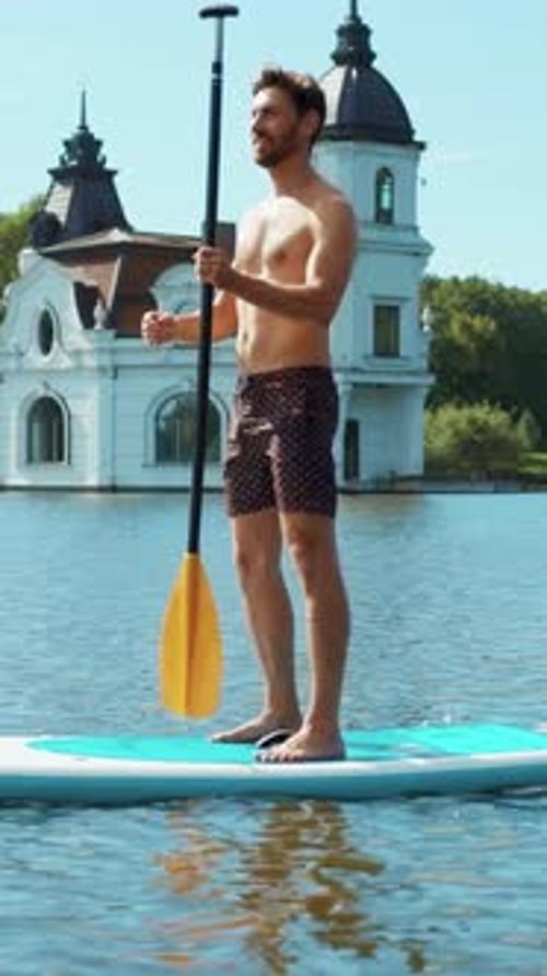 Man Paddling on a Paddle Board on Water