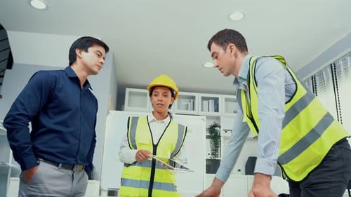Architects Reviewing Construction Plans in Modern Office