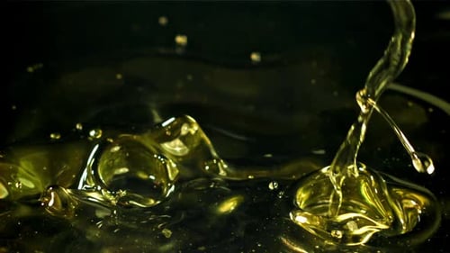 Golden Liquid Pouring in Slow Motion