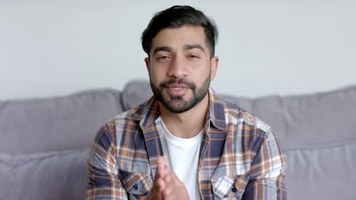 Young Man Talking on Video Call at Home