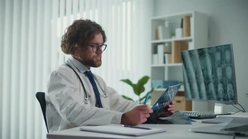 Doctor Reviews Xrays and CT Scans Analyzing Digital Medical Data