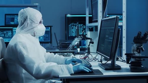 Microelectronics Engineer Works in a Modern Scientific Laboratory on Computing Systems and