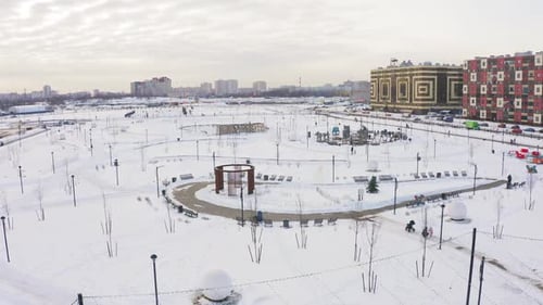 Aerial Motion Above Park with Playgrounds on Winter Day