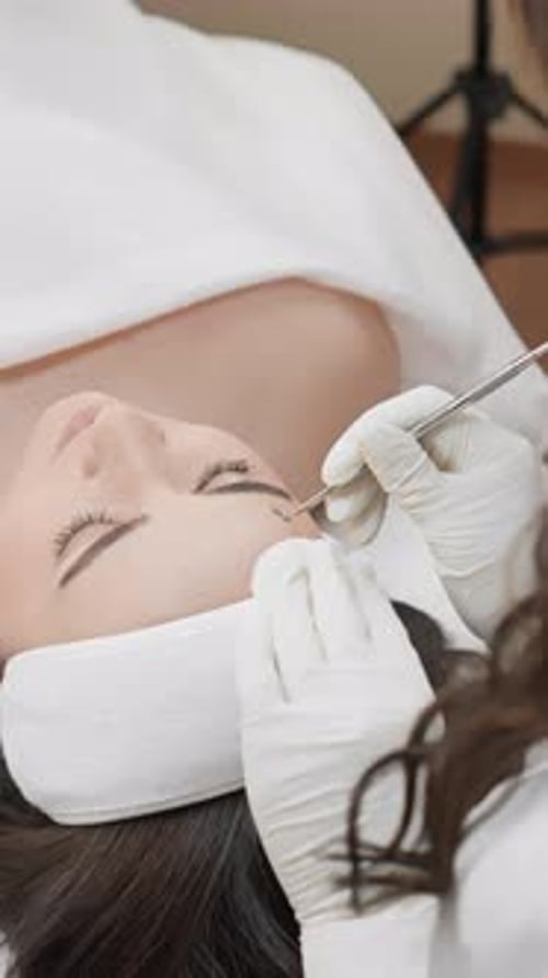 Experience a Professional Facial Treatment at the Spa As an Esthetician Cleanses a Clients Skin This
