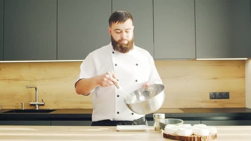 Chef mixing ingredients in a bowl with a whisk