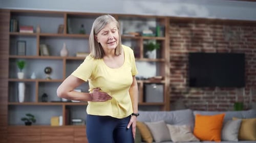 Senior mature woman pain in the right side of the abdomen, appendix, gynecological diseases. Elderly