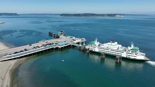 Orbiting aerial of a docked ferry unloading its passengers.