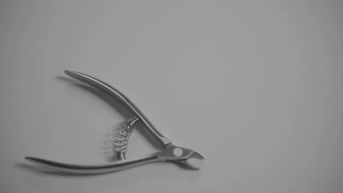 Hand Arranging Metallic Cuticle Nippers Close Up