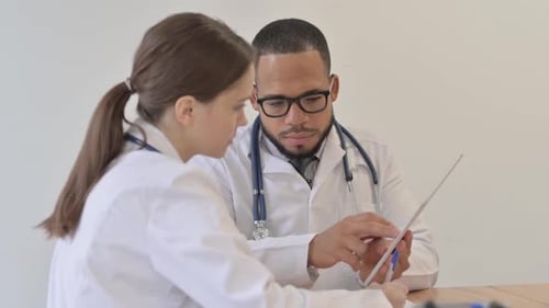 Doctors Reviewing Data on Tablet in Office