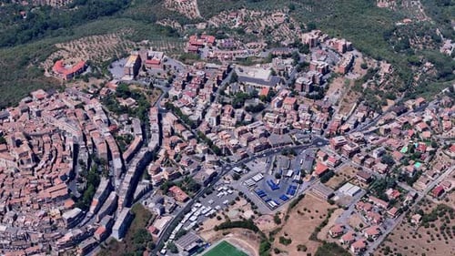 Camera panning over small italian town on hillside