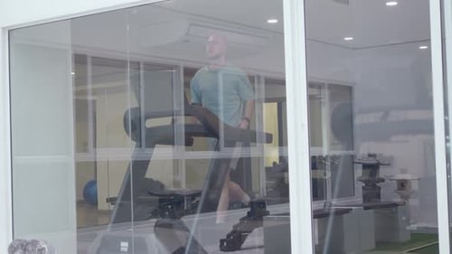 Cardio Workout and Healthy Lifestyle Concept with Modern Fitness Equipment Behind Window Emphasizing
