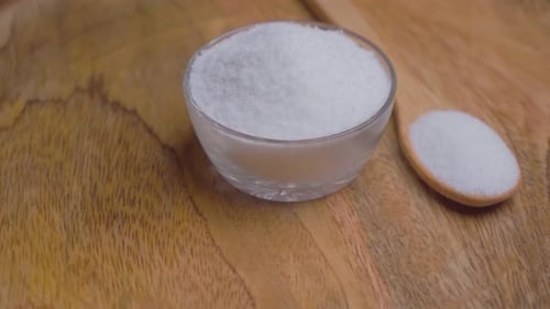 Bowl and Spoon Filled with White Granules