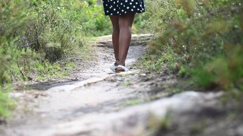 Low angle view of woman walking through pathway