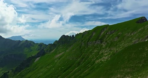 Drone Flies Over Green Picturesque Valley with Mountains in the Background High Mountains Famous