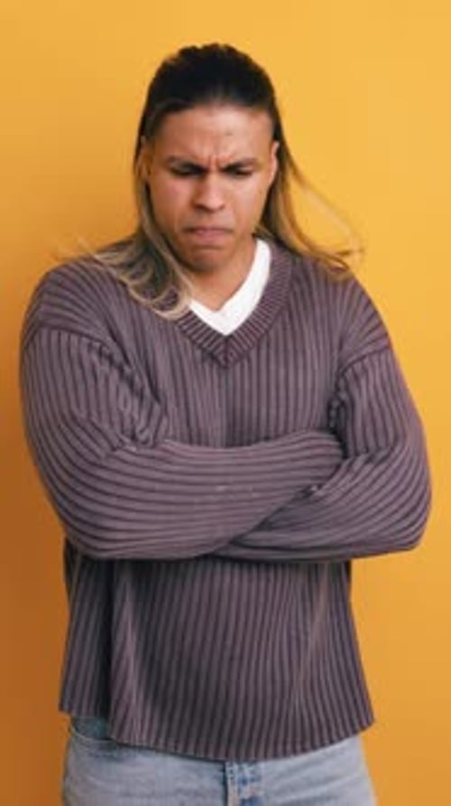 Disgusted Latino Man Crossing Arms with Angry Expression Vertical