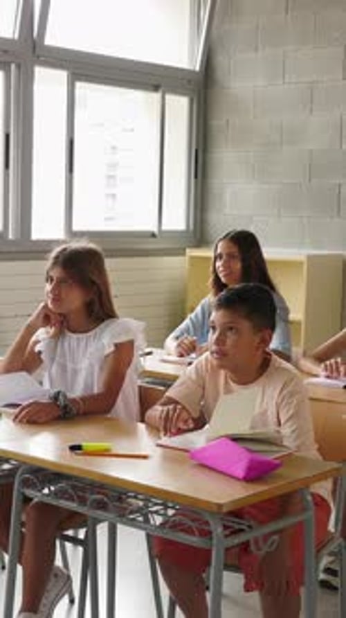 Enthusiastic Students Raise Hands in Class