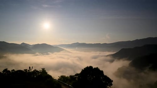 The orange-red glow of the sunrise illuminated the raging sea of clouds.