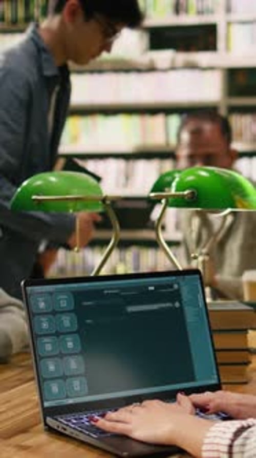 Vertical Video Student Using AI Study Assistant Interface on Laptop During Group Study Session