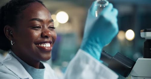 Woman Scientist Uses Microscope in Laboratory