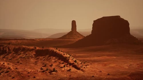 A Majestic Desert Landscape with a Prominent Rock Formation in the Center