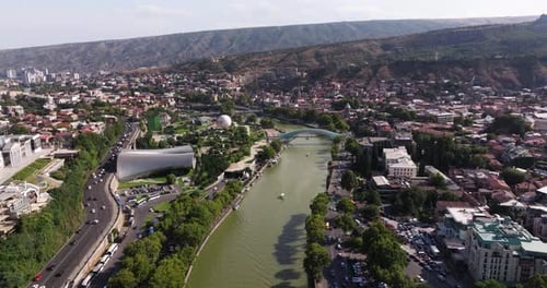 Cinematic Drone Shot Above Kura River in Downtown Tbilisi, Georgia. Summer