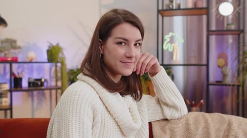 Smiling Woman Resting on Hand at Home
