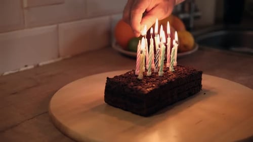 Lighting Candles on Birthday Cake in Cozy Kitchen