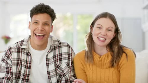 Cheerful Couple Laughing and Waving Into Camera