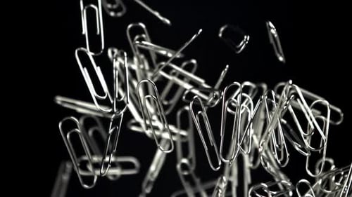 Silver Paper Clips Floating on a Black Background