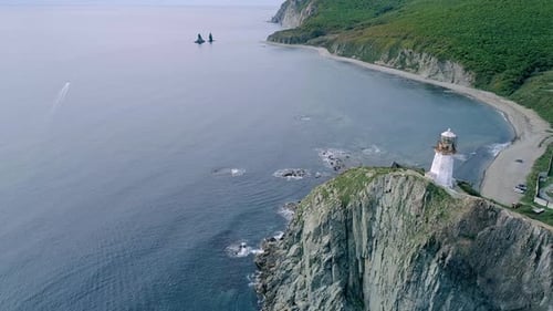 Aerial Tilt View of an Old Lighthouse on the Cliff on Pacific Coast Beautiful Panoramic Seascape